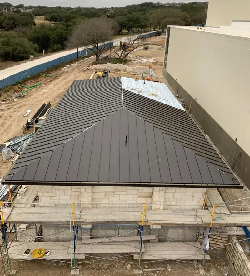 Metal roof new construction with scaffolding in Quincy